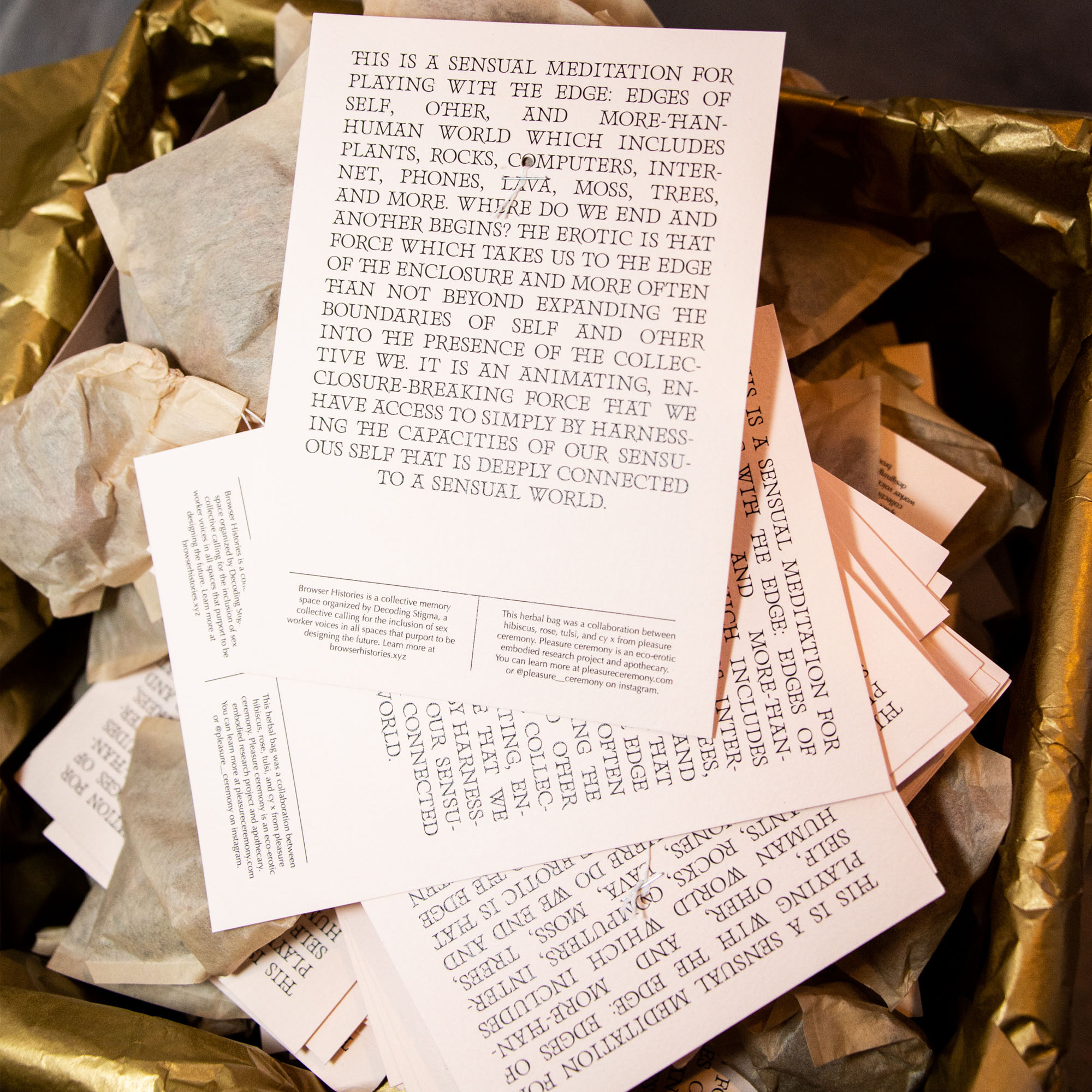 A stack of cards shows a meditation printed on light pink paper.