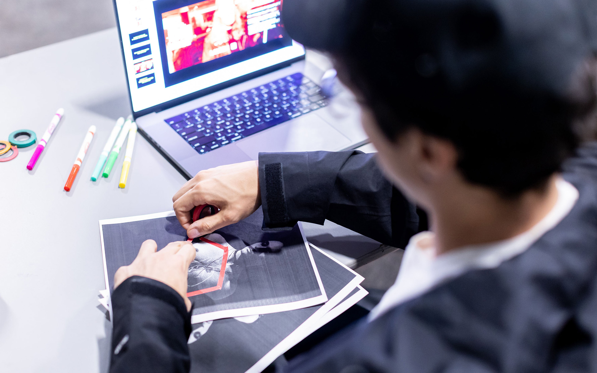 Looking over the shoulder of a workshop participant as they annotate a printed image.